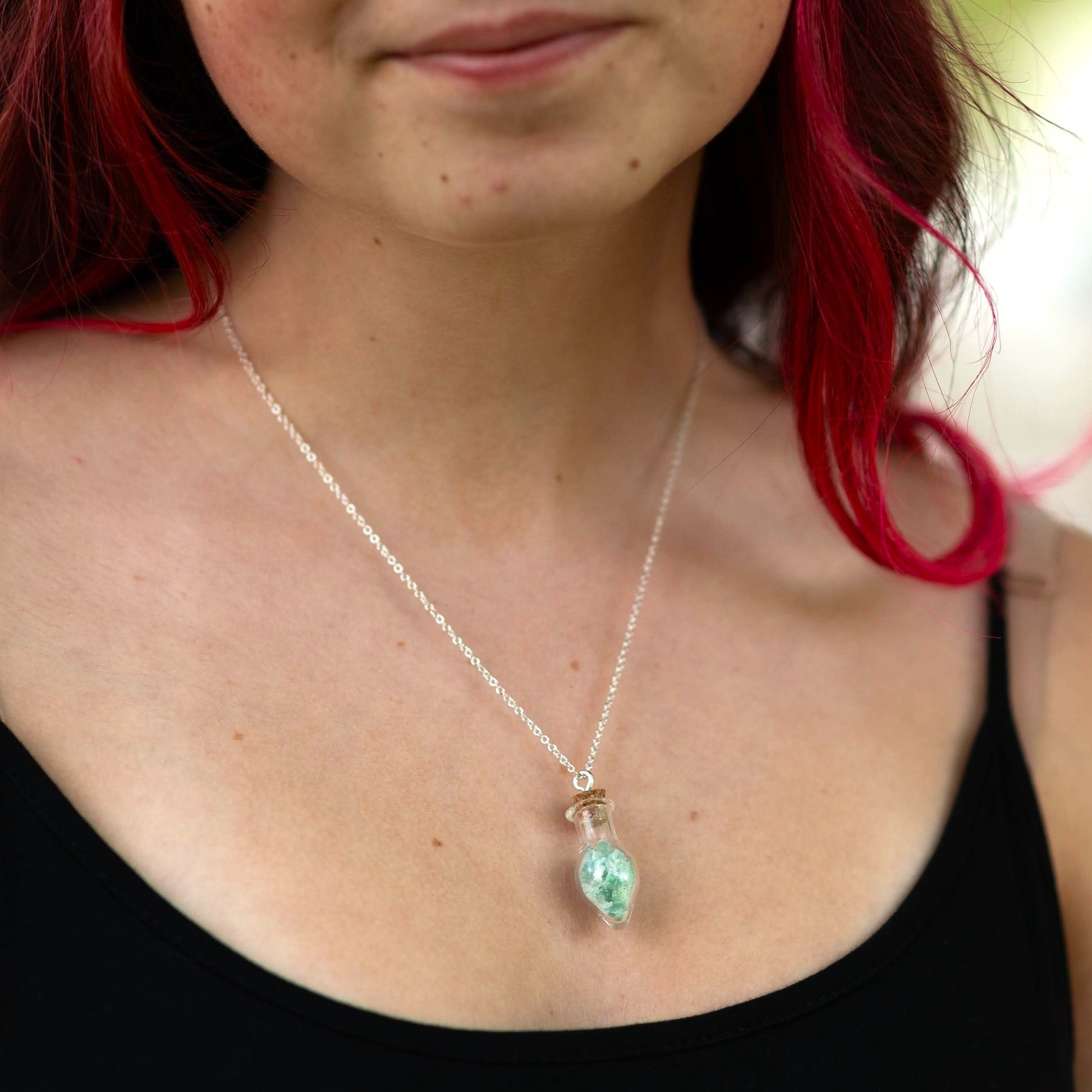 Mini glass bottles of gemstone chips - pendant on chain - on model