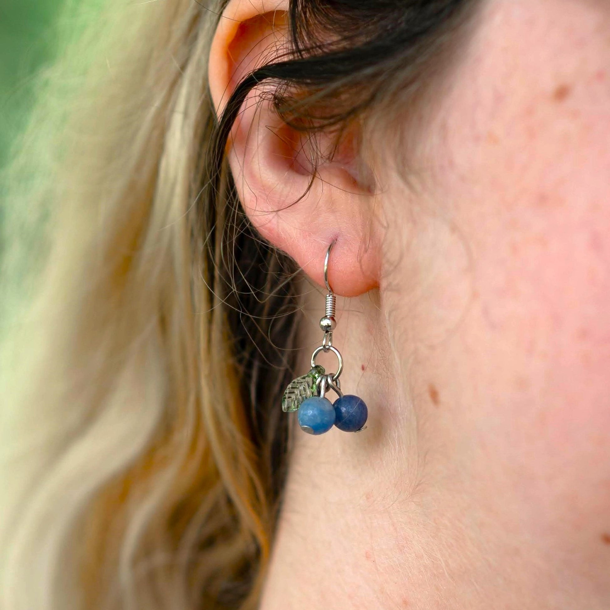 Blue Aventurine Blueberry Earrings with Green Leaf Accents on ear